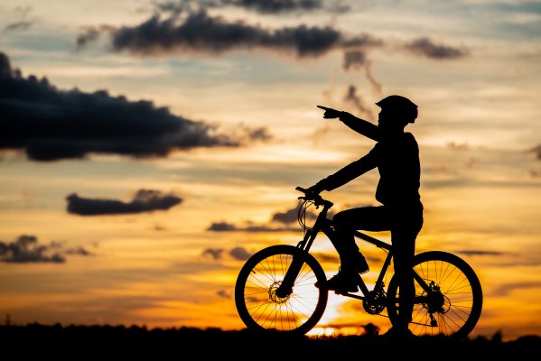 cyclist resting silhouette at sunset active outdoor sport concept